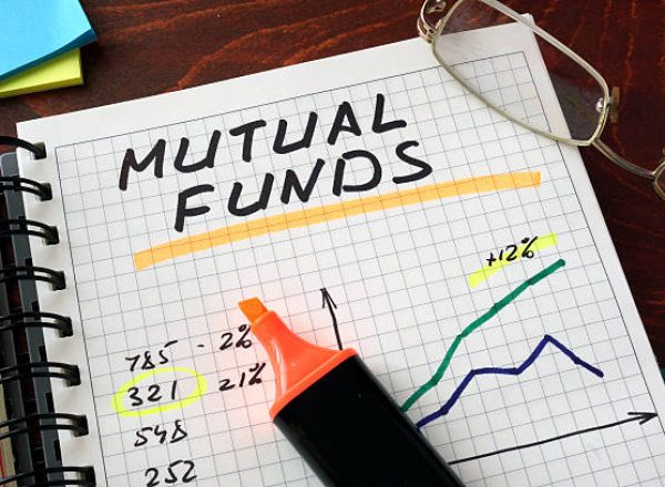 Notebook with  mutual funds sign on a table. Business concept.
