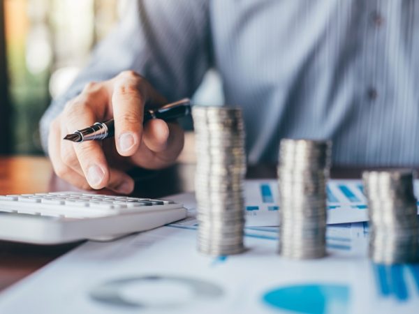 Businessman accountant counting money and making notes at report doing finances and calculate about cost of investment and analyzing financial data, Financing Accounting Banking Concept.